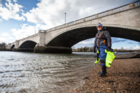 Kieran Clark on the shore of the Thames at Tideway Scullers